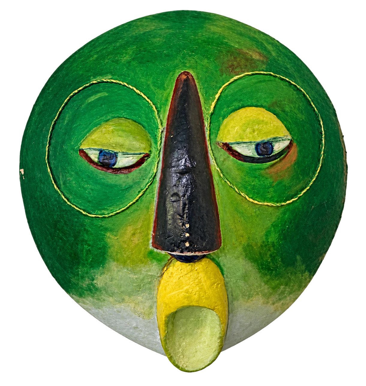 A circular green mask with a long dark nose and half-closed eyes, displayed beneath a wall light.